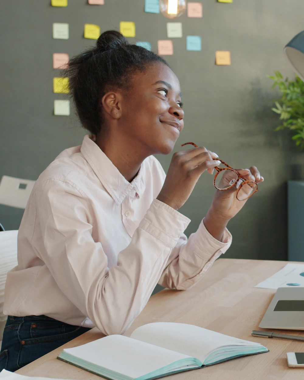 Entrepreneur thinking about a project in front of a wall of sticky notes